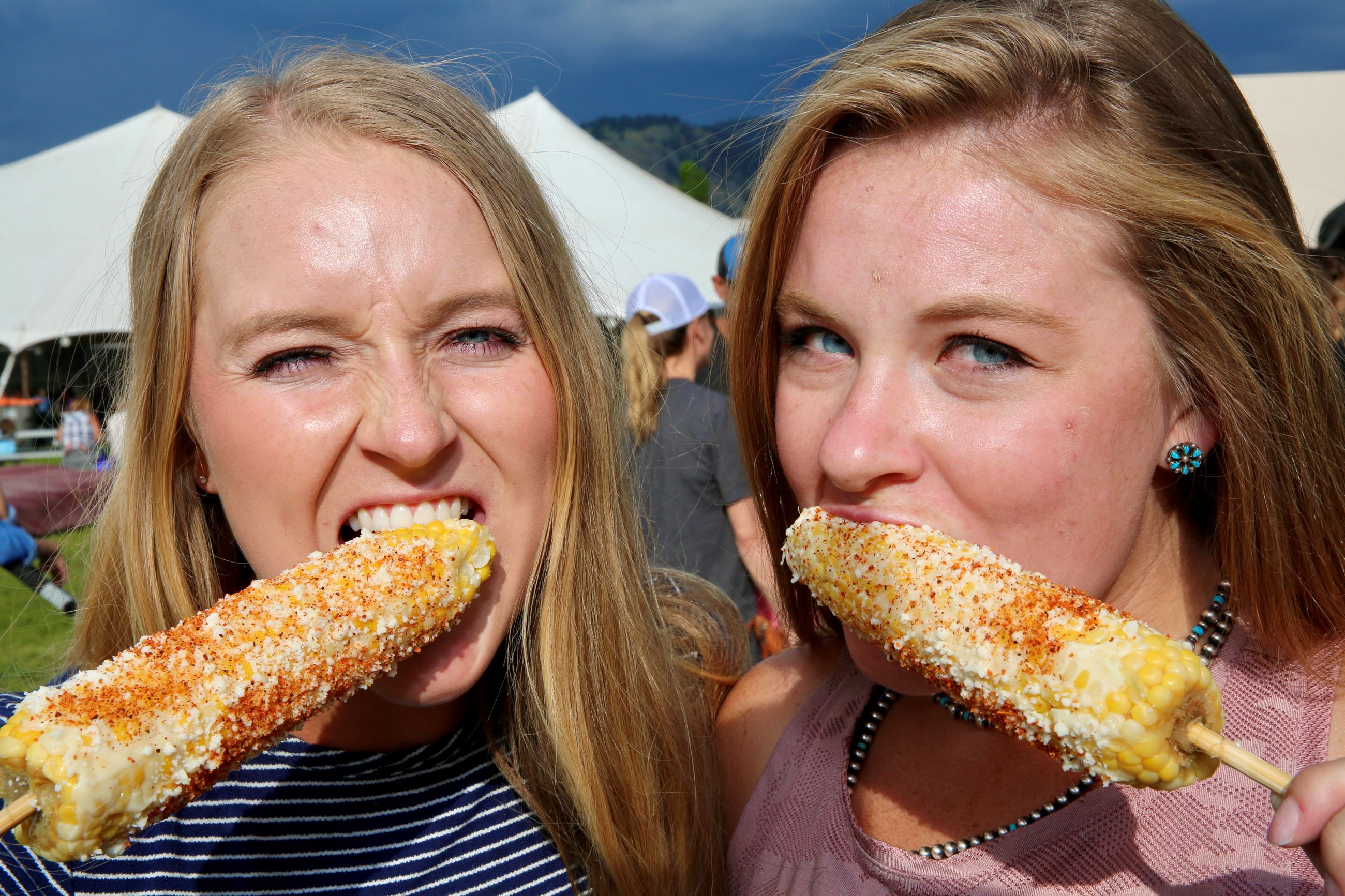 Two Women Enjoy Corn on the Cob